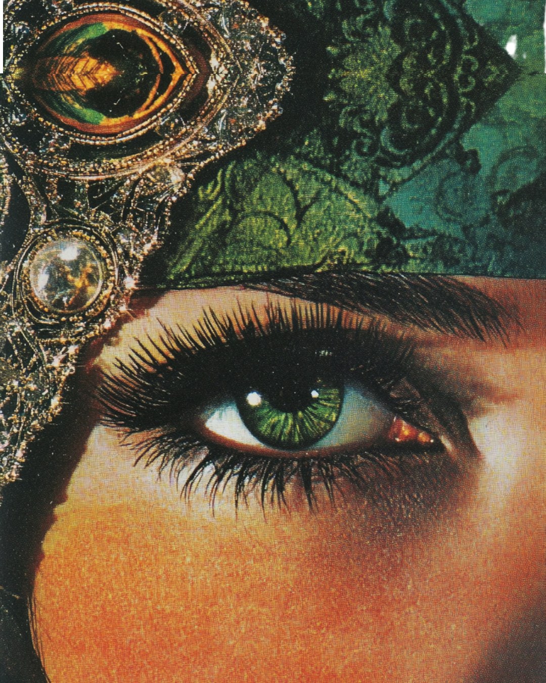 A green eye beneath an ornate jewelled headdress